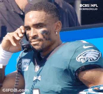 Man In Black Hat In Front Of NFL Logo GIF