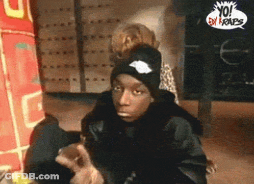 Man In Black Hat In Front Of Yo! By Crabs Sign GIF