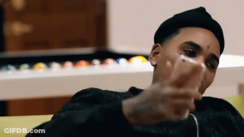 Man In Black Hat Looking At Phone On Couch GIF