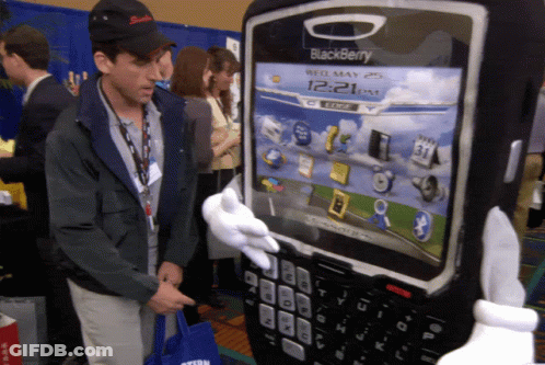 Man In Black Hat Next To Giant Blackberry GIF