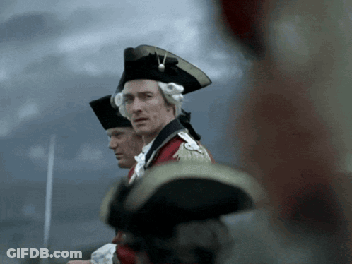 Man In Black Hat Next To Man In Red Coat GIF