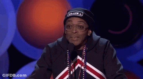 Man In Black Hat Saying Black At Microphone GIF