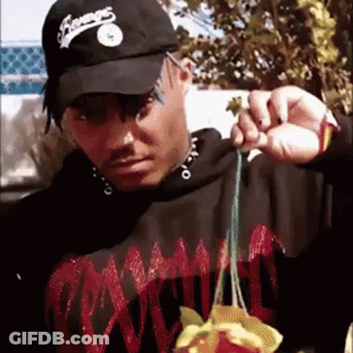 Man In Black Hat Saying Champs Holding Something GIF