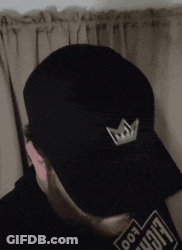 Man In Black Hat With Crown And Foo Shirt GIF
