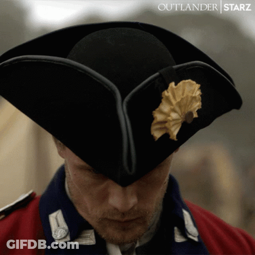 Man In Black Hat With Yellow Flower Outlander Starz GIF