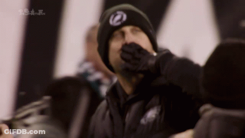 Man In Black Hat With Z Covering Mouth GIF