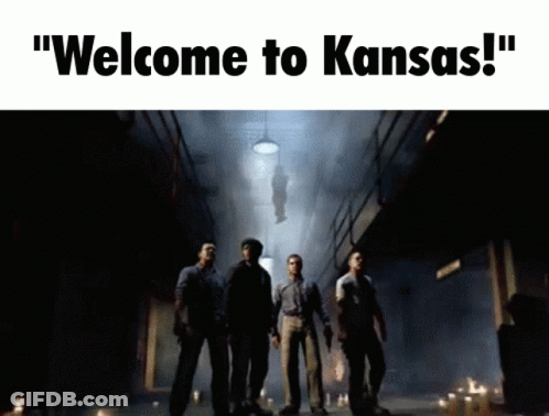 Man In Black Helmet And Tuxedo Beside Another Man GIF