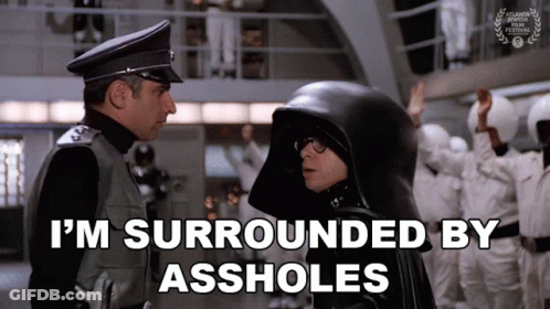 Man In Black Helmet Surrounded By Assholes GIF