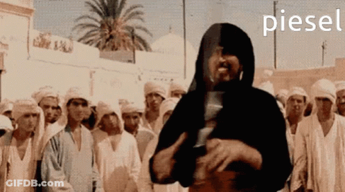Man In Black Hood In Front Of Crowd Piesel GIF
