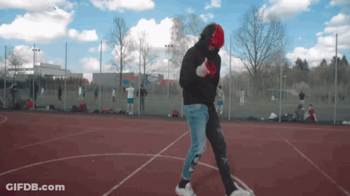 Man In Black Hoodie And Red Mask Walking GIF