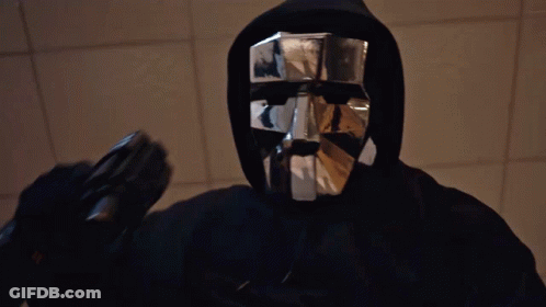 Man In Black Hoodie And Silver Mask Holding Gun GIF