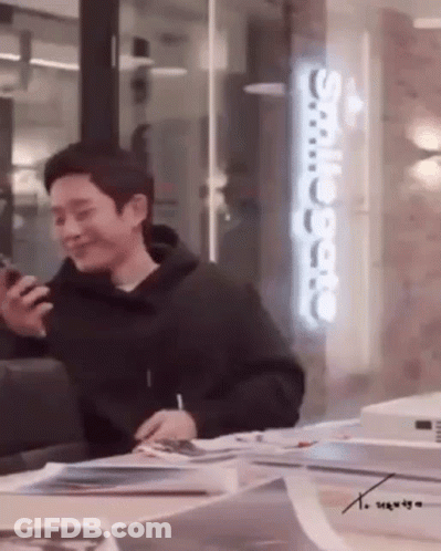 Man In Black Hoodie Holding Cell Phone GIF