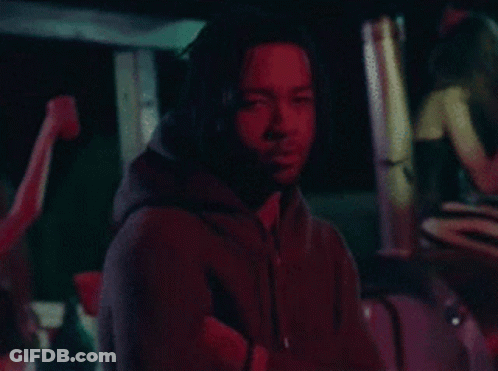 Man In Black Hoodie In Dark Room With Red Light GIF