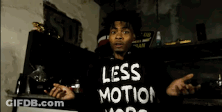 Man In Black Hoodie In Front Of Brick Wall GIF
