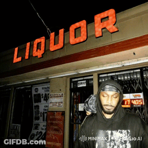 Man In Black Hoodie In Front Of Liquor Store GIF