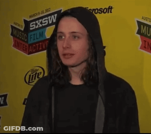 Man In Black Hoodie In Front Of SXSW Sign GIF