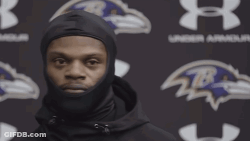 Man In Black Hoodie In Front Of Under Armour Logo GIF