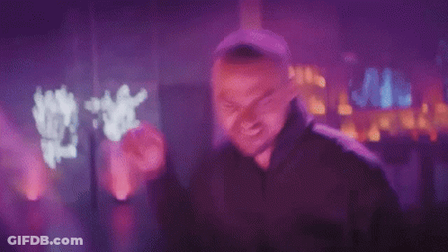 Man In Black Hoodie Making Funny Face In Purple Light GIF