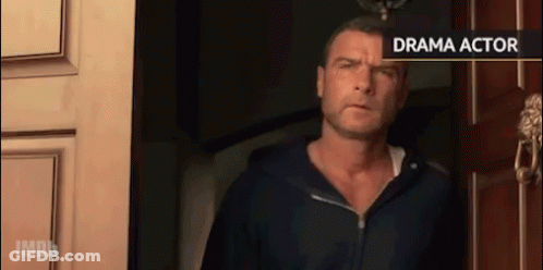 Man In Black Hoodie Standing In Front Of Drama Actor Sign GIF