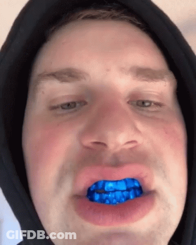 Man In Black Hoodie With Blue Teeth GIF