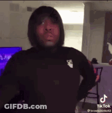 Man In Black Hoodie With Hands On Hips GIF