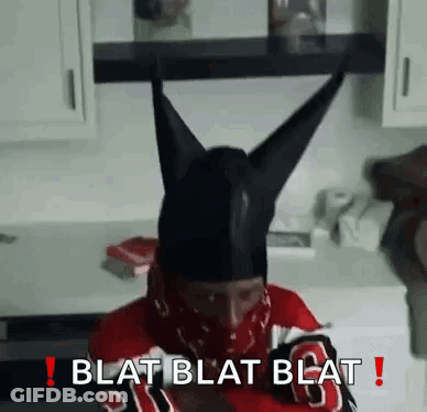 Man In Black Horned Hat And Bandana Sitting In Kitchen GIF