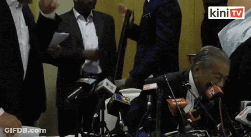 Man In Black Jacket Adjusting Collar GIF