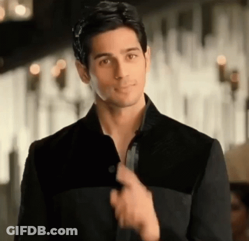 Man In Black Jacket Adjusting Collar GIF