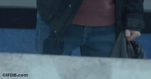 Man In Black Jacket And Blue Jeans Holding Jacket GIF