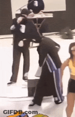 Man In Black Jacket And Blue Pants With Woman In Yellow Tank Top GIF