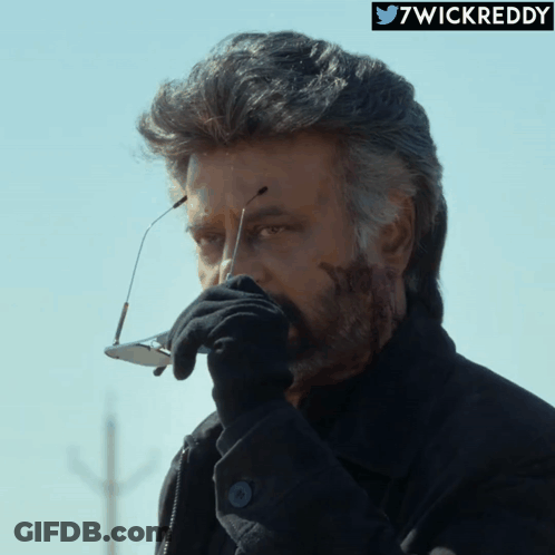 Man In Black Jacket And Glove Holding Glasses GIF