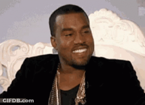 Man In Black Jacket And Gold Chains Smiling GIF
