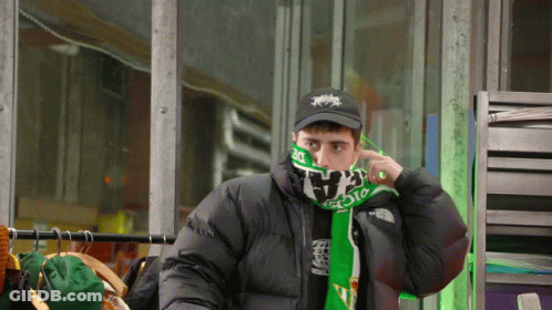 Man In Black Jacket And Green Scarf Saying The North Face GIF