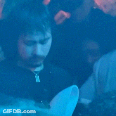 Man In Black Jacket And Green Scarf Saying The North Face GIF