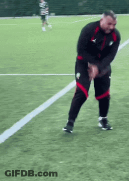 Man In Black Jacket And Red Shorts On Soccer Field GIF