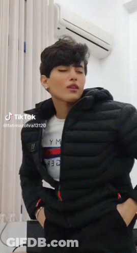 Man In Black Jacket And Tommy Hilfiger Shirt By Air Conditioner GIF