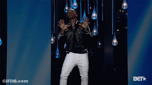 Man In Black Jacket And White Pants In Front Of BET Logo GIF