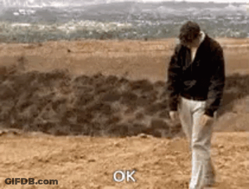 Man In Black Jacket And White Pants Saying Ok GIF