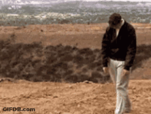 Man In Black Jacket And White Pants Walking GIF