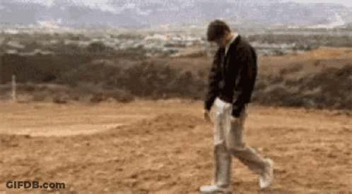 Man In Black Jacket And White Pants Walking GIF