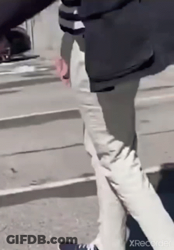 Man In Black Jacket And White Pants Walking GIF