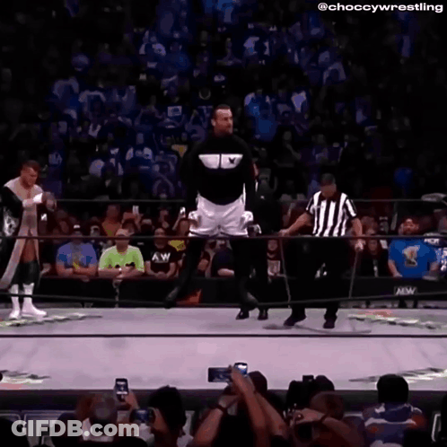 Man In Black Jacket And White Shorts In Wrestling Ring GIF