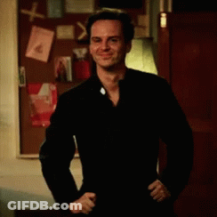 Man In Black Jacket At Bulletin Board GIF