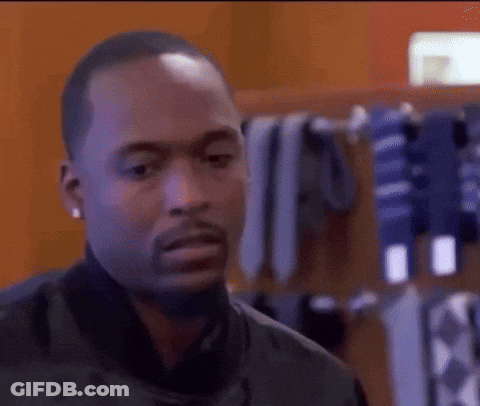 Man In Black Jacket At Rack Of Ties GIF
