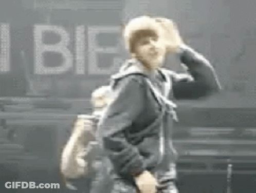 Man In Black Jacket Beside I Bieber Sign GIF