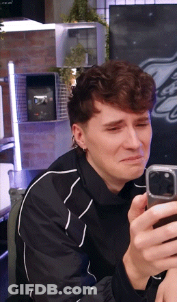 Man In Black Jacket Crying With Cell Phone GIF