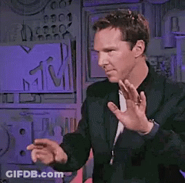 Man In Black Jacket Dancing In Front Of MTV Sign GIF