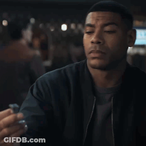 Man In Black Jacket Eyes Closed Holding Something GIF