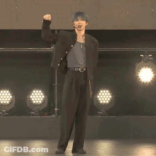 Man In Black Jacket Facing Row Of Lights GIF