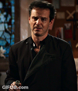 Man In Black Jacket Holding Chest GIF
